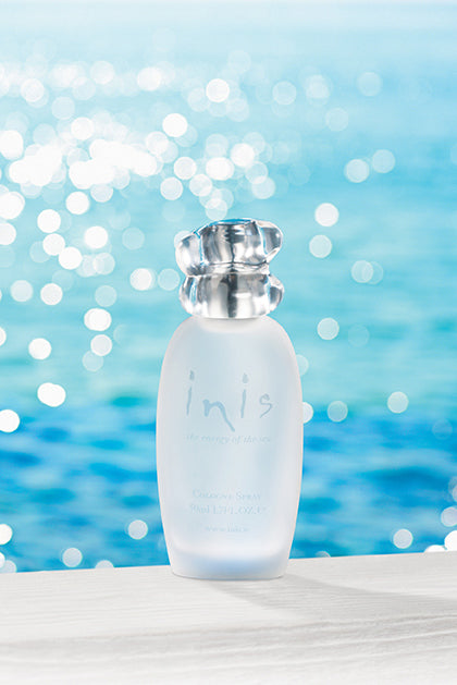 Perfume bottle labeled 'inis' with a sparkling water background