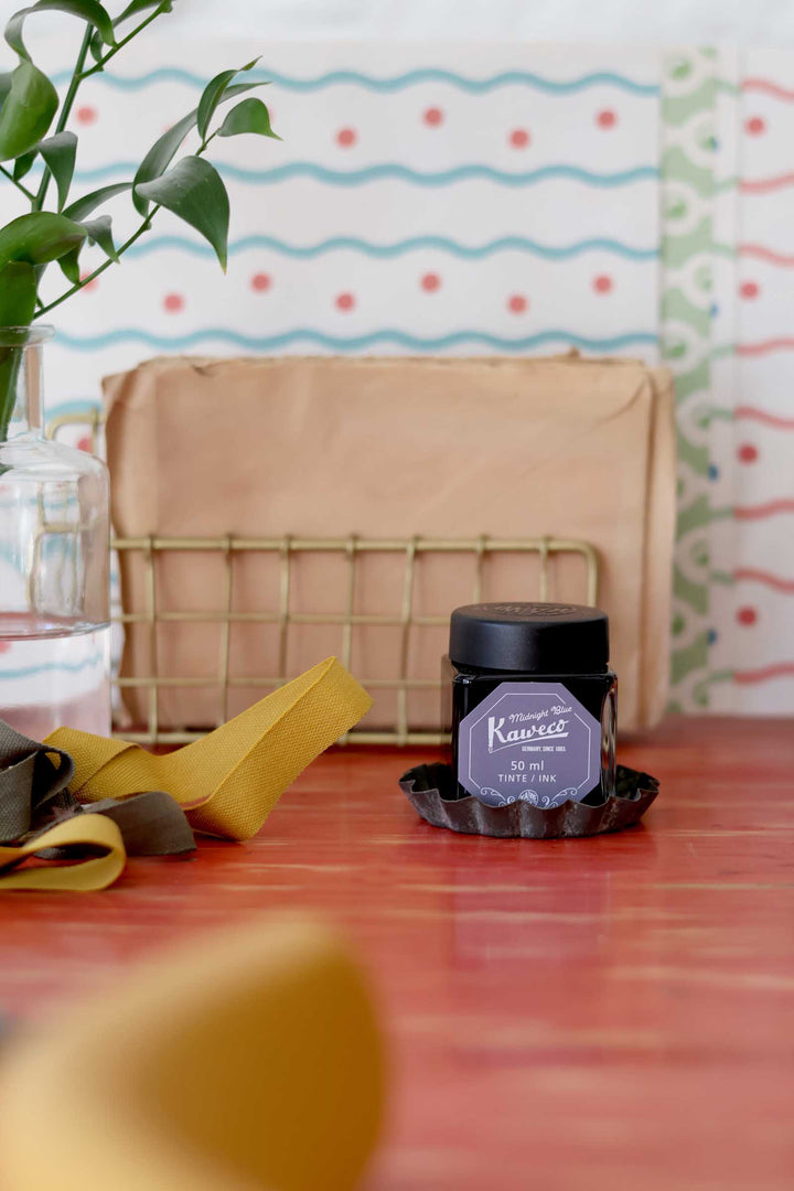 Jar of Kawaii Studio product on a wooden surface with a colorful polka dot curtain in the background.