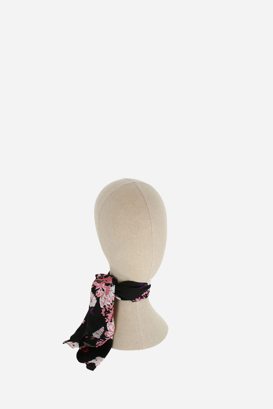 Floral headband on a mannequin head against a white background