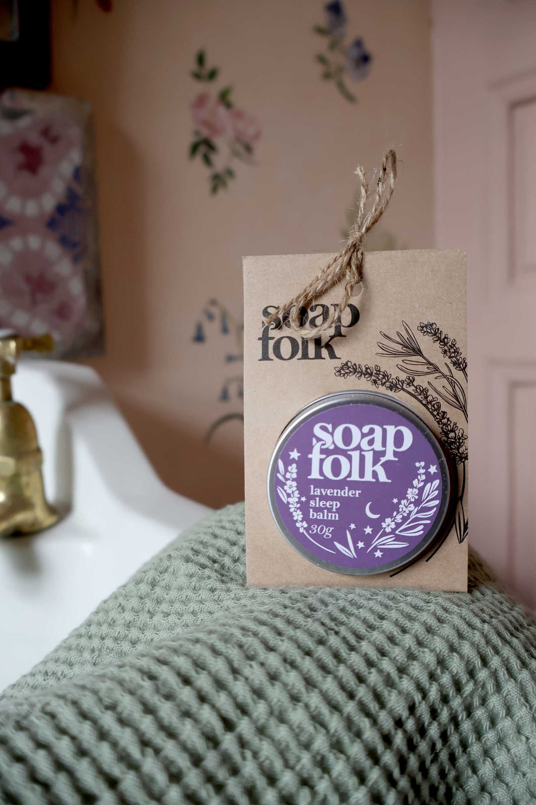 Soap Folk product with a tag on a textured surface