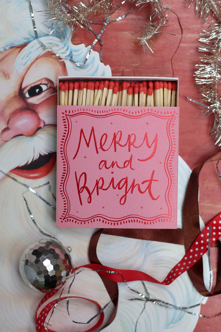 A pink matchbox with &