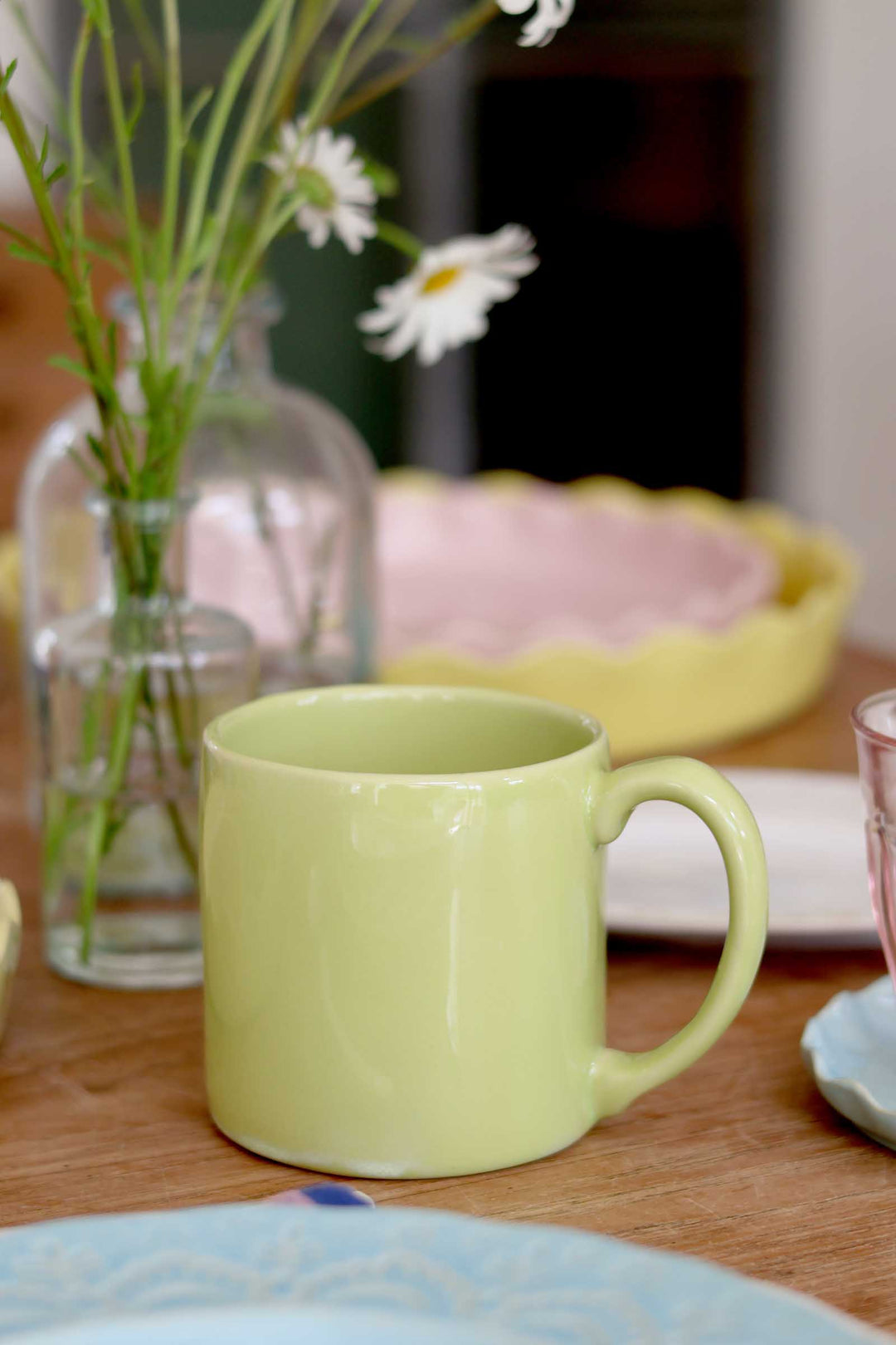 Green mug on a table with a blurred background