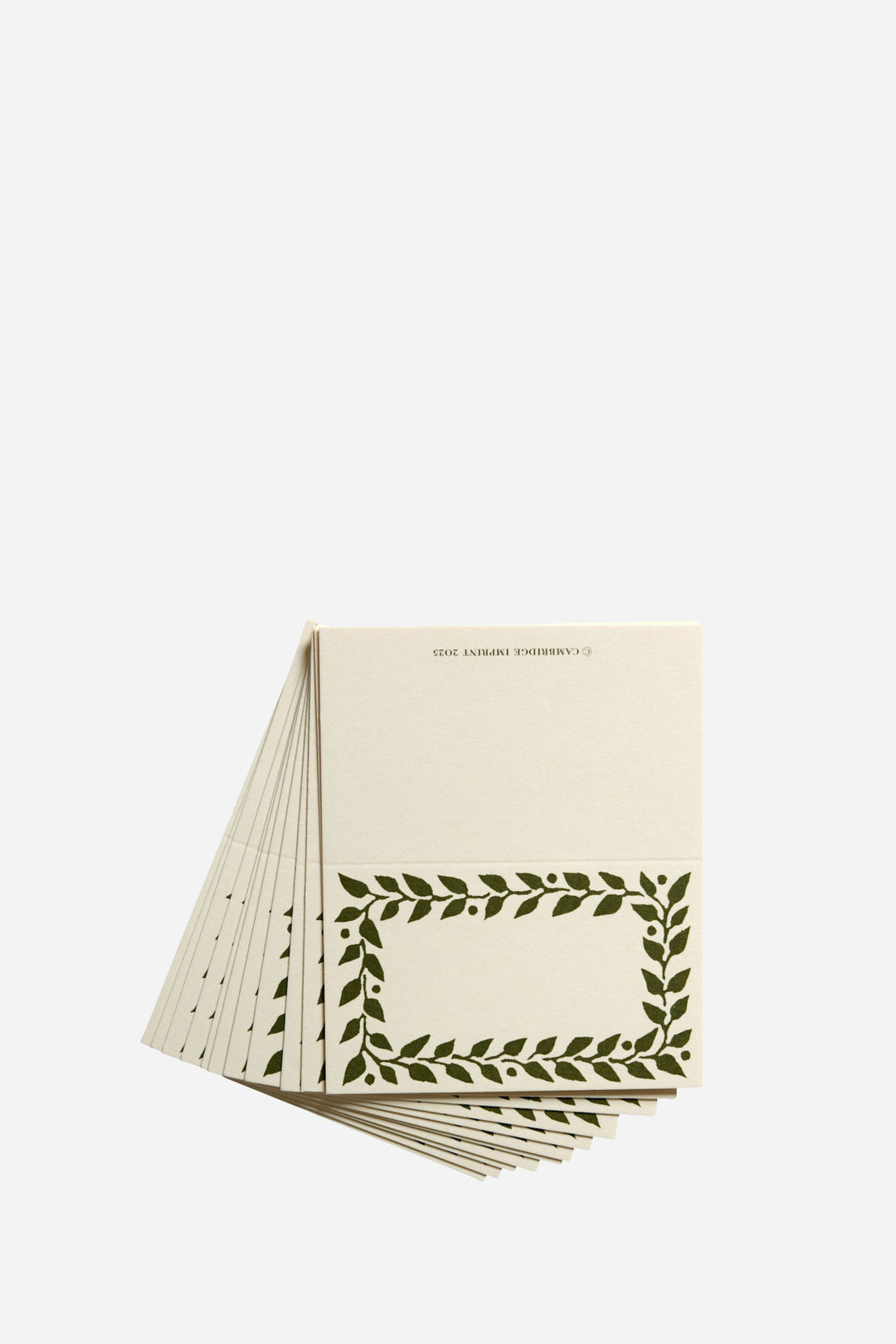 Stack of notebooks with green leaf pattern on a white background
