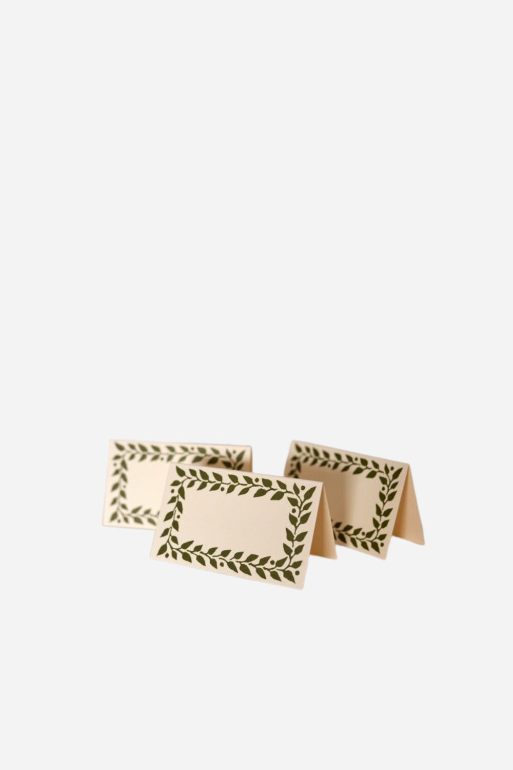 Set of three folded paper place cards with leaf pattern on a white background