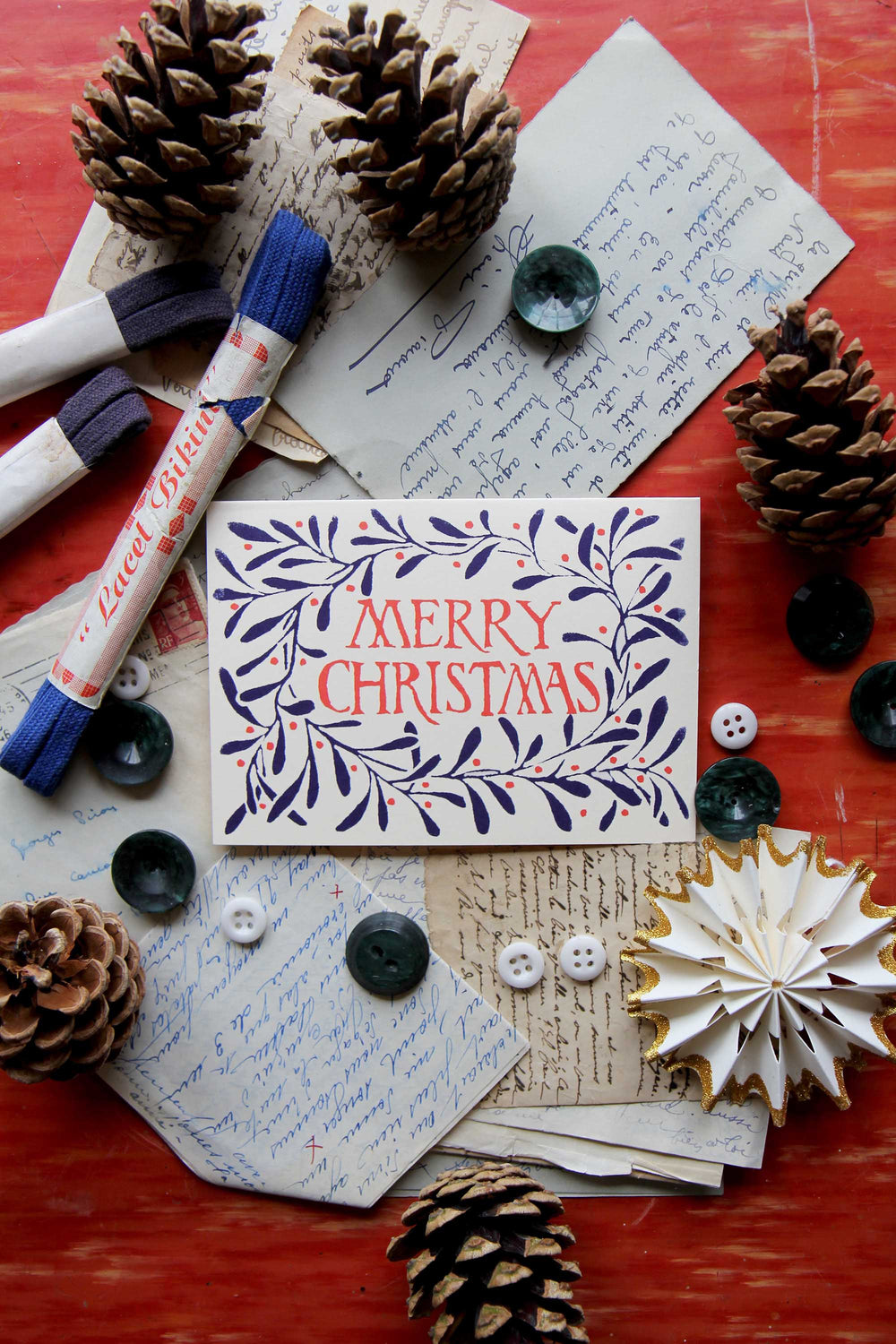 Merry Christmas card with decorative elements on a textured surface