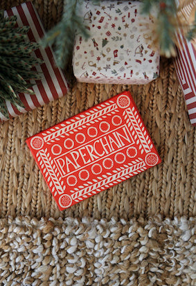 pack of red and white paper chains with wrapped gifts and Christmas decorations.