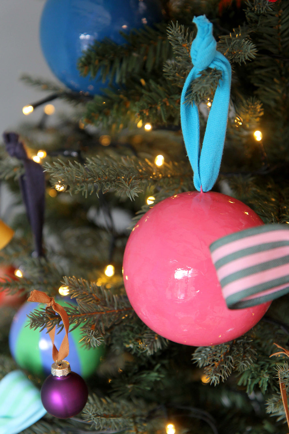 Close-up of a Christmas tree with colorful ornaments and lights.