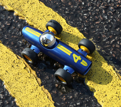 Blue toy car with yellow accents on a road with yellow lines