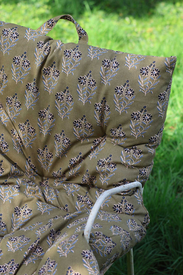 Floral-patterned umbrella on a grassy background