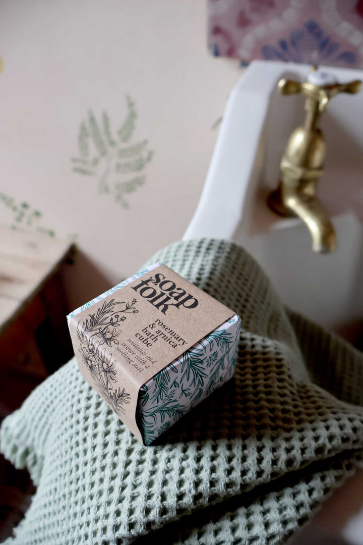 Bar of soap on a textured surface with a blurred background