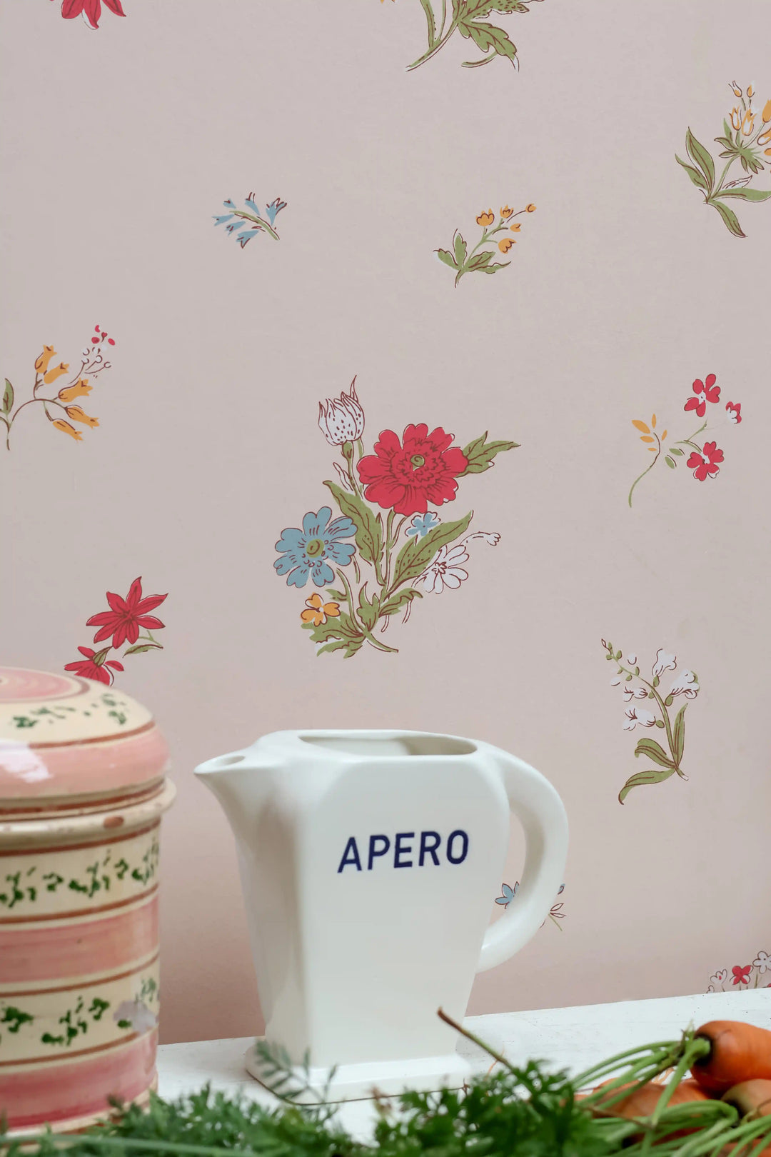 A white ceramic pitcher with the word &