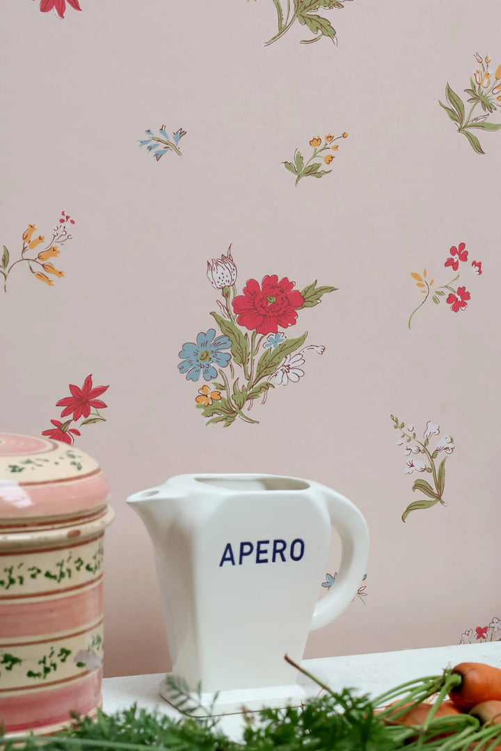 A white ceramic pitcher with the word &