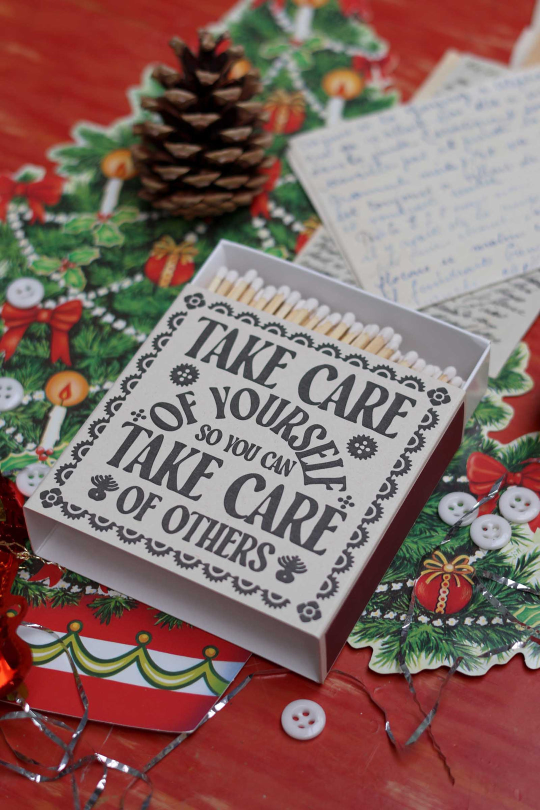 A Christmas-themed matchbox with the quote &