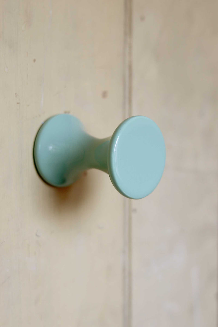 Light blue knob on a wooden door