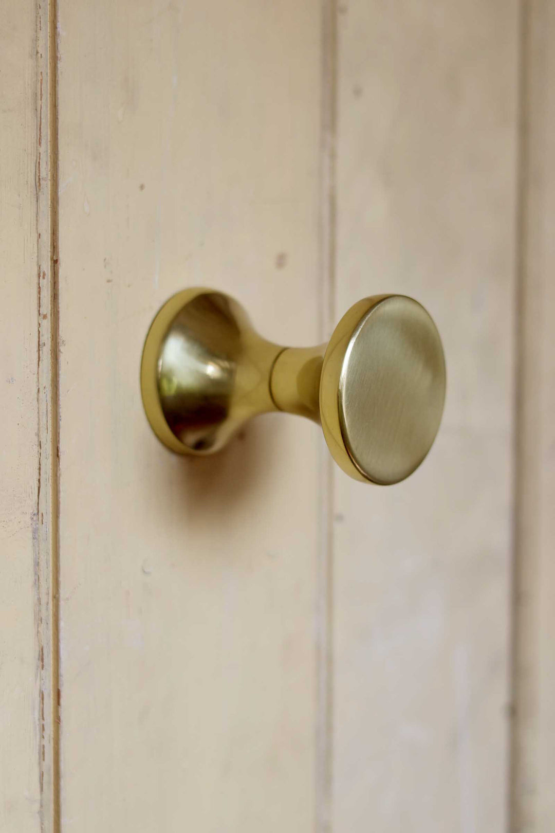 Brass door handle on a wooden door