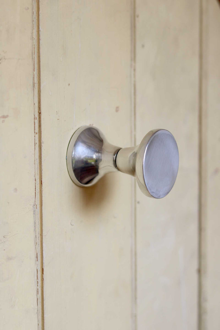 Metal door handle on a wooden door