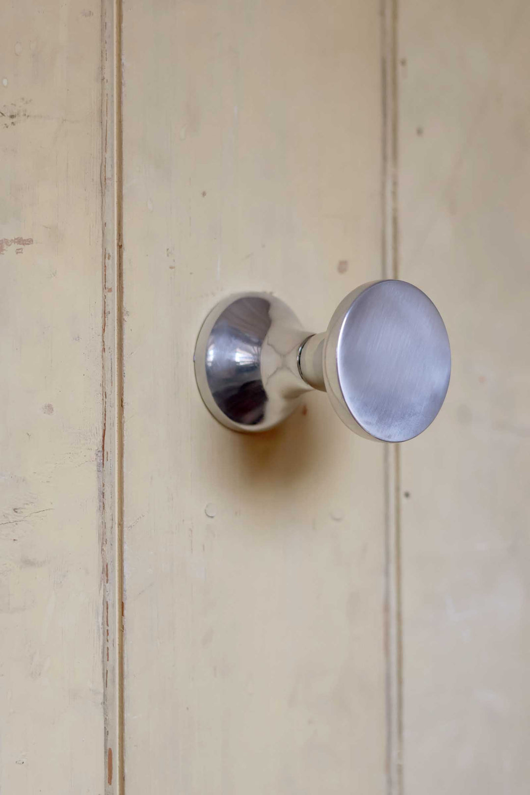 Metal door handle on a wooden door