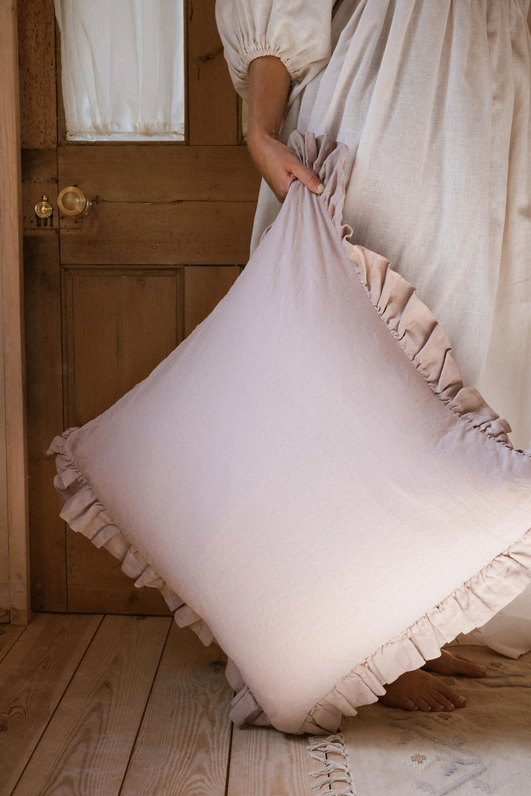 pink pillow in front of wooden door