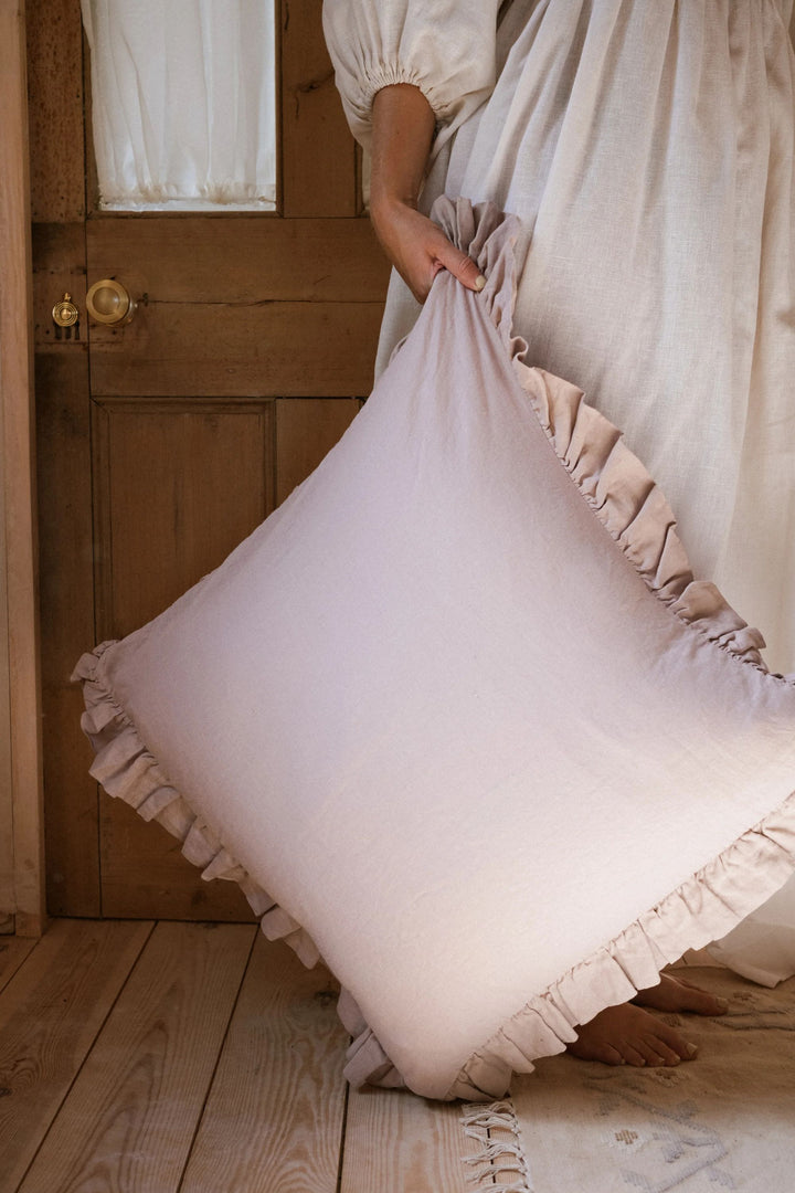 pink pillow in front of wooden door