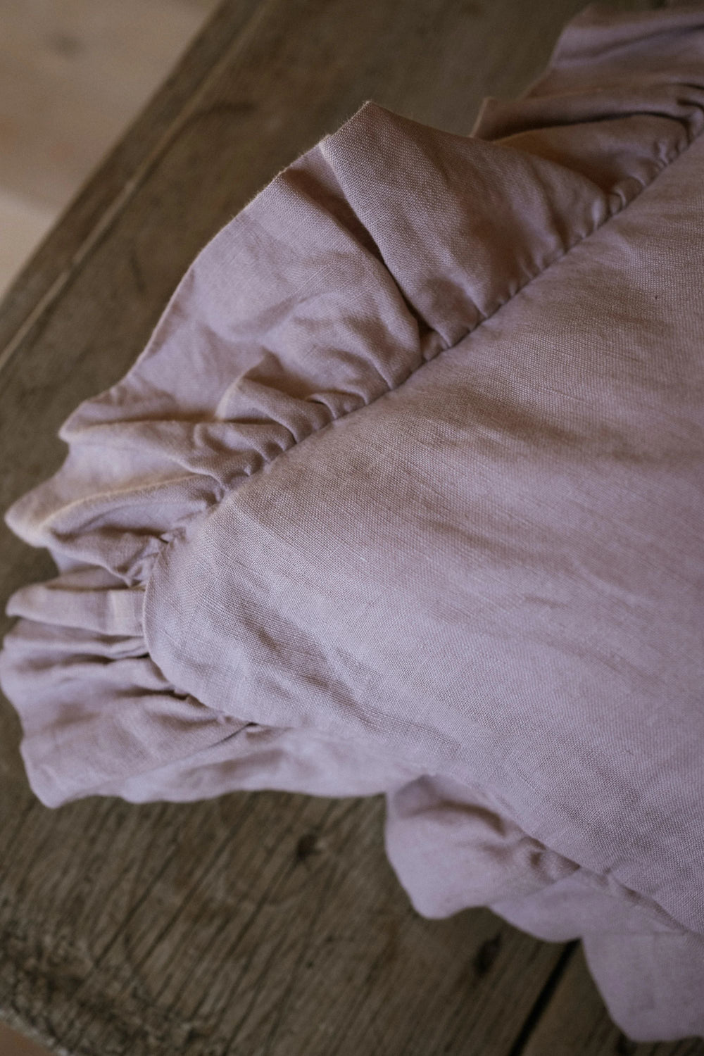 Close-up of a pink fabric garment on a wooden surface