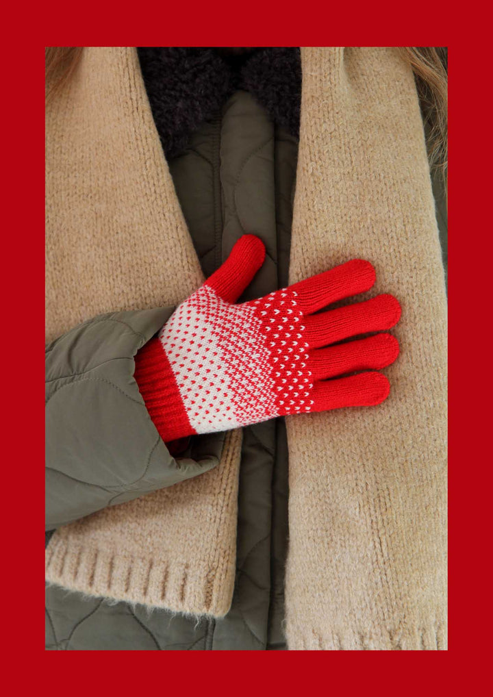 Red and white patterned glove on a beige scarf with a red background