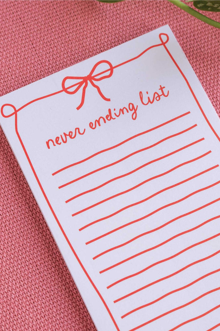 never ending list notepad on pink backround
