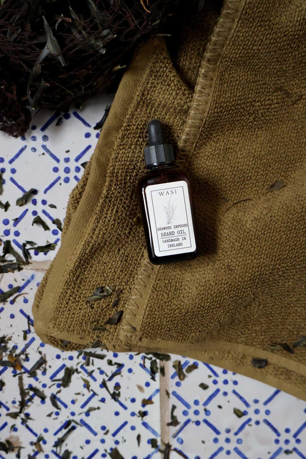 Bottle of hand gel on a textured surface with a patterned background