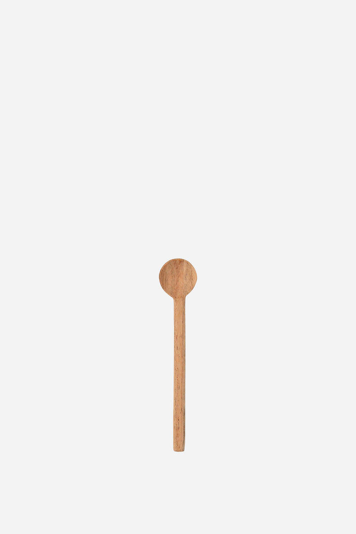Wooden spoon on a light beige background