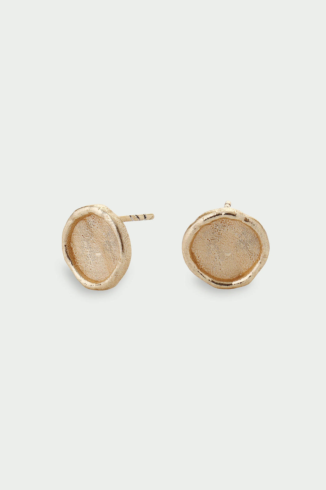 Pair of gold earrings on a light gray background