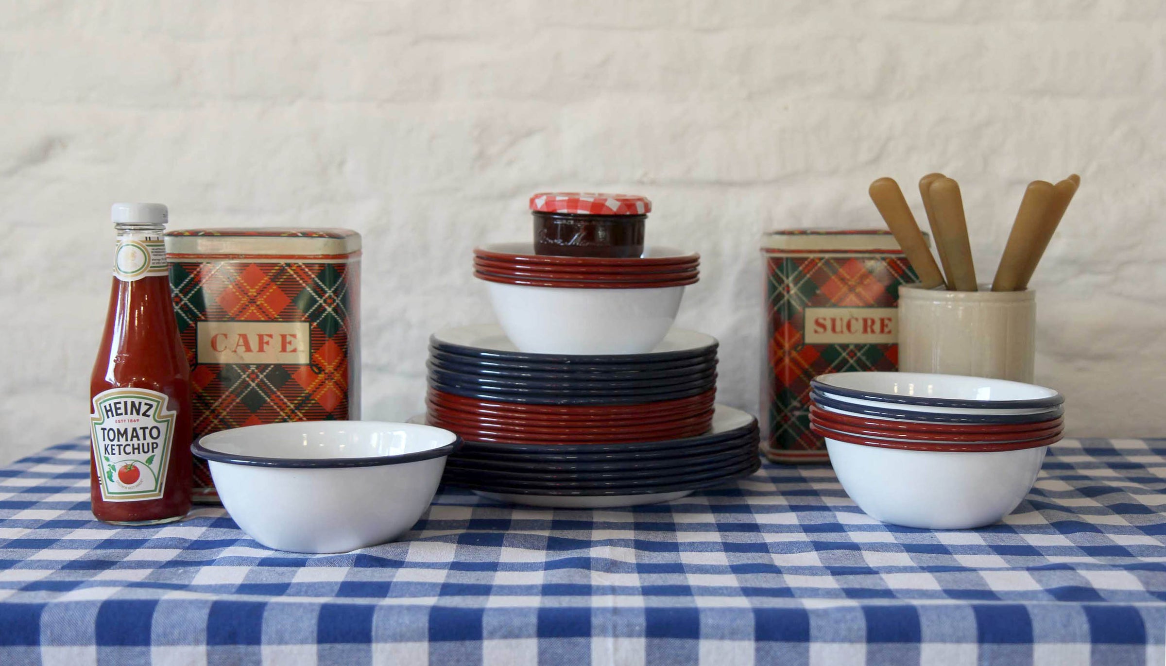blue gingham tablecloth set with traditional blue and white enamel and vintage storage tins