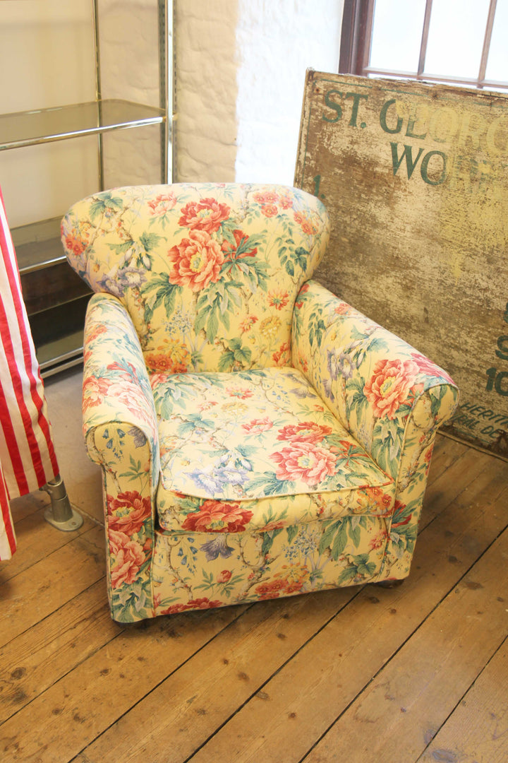 yellow, red and green floral upholstered vintage armchair in domestic science shop