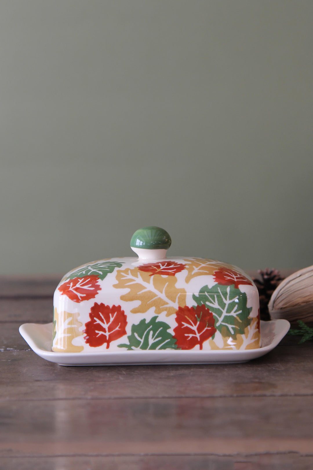 Butter dish with leaf pattern on a wooden surface