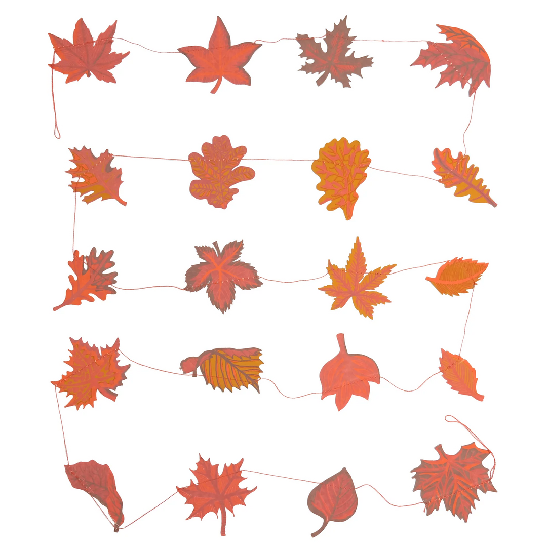 String of red and orange leaf decorations on a white background