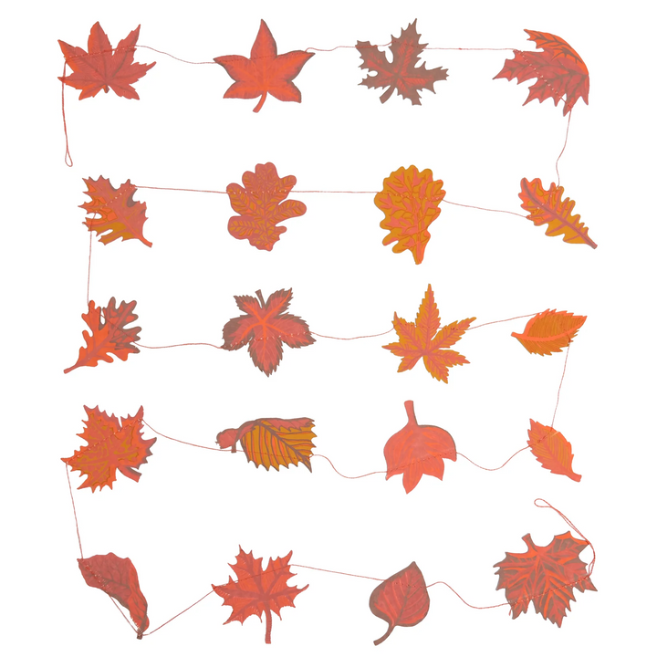 String of red and orange leaf decorations on a white background