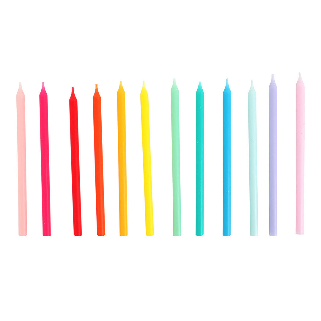 Set of colorful candles arranged in a row on a white background