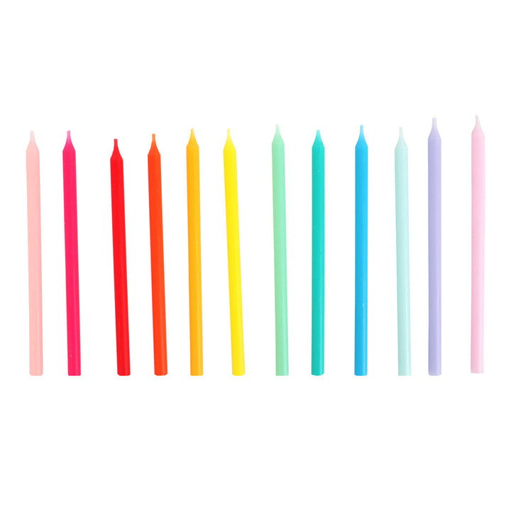 Set of colorful candles arranged in a row on a white background