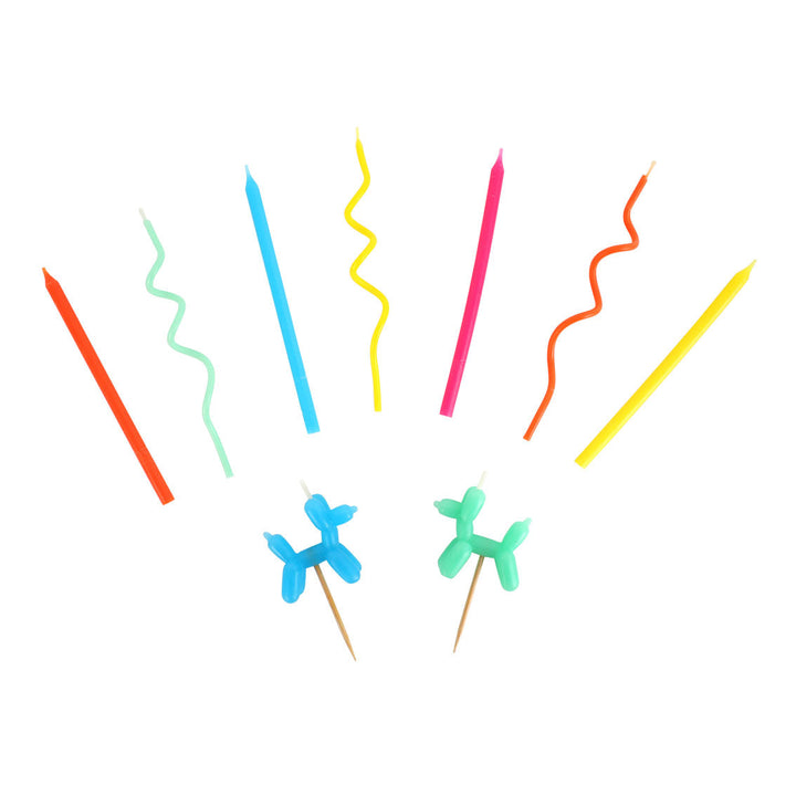 Colourful novelty shaped candles on a white background