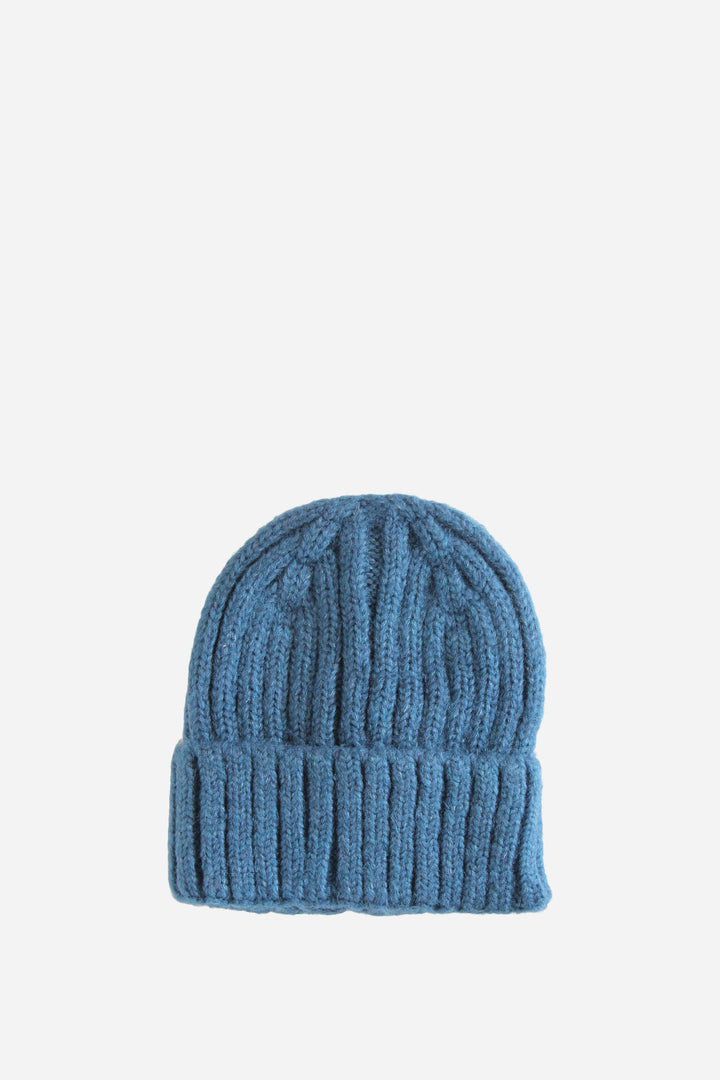 Blue knit beanie on a light blue background