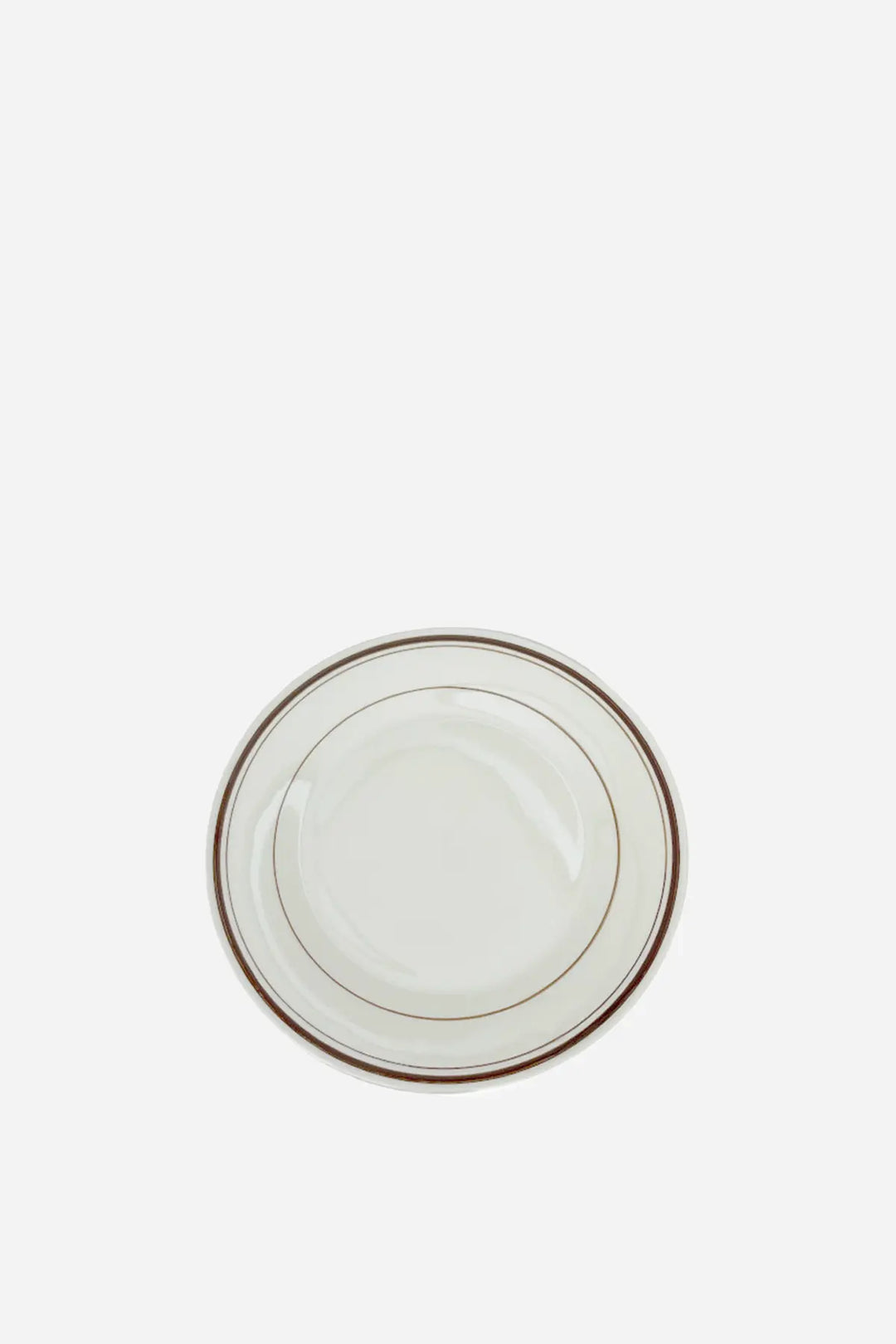 White ceramic plate with gold rim on a white background