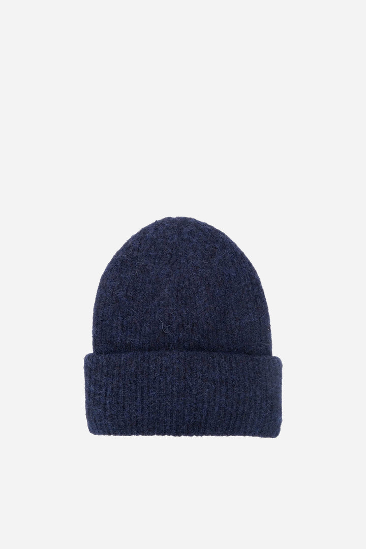 Navy blue knit beanie on a light gray background