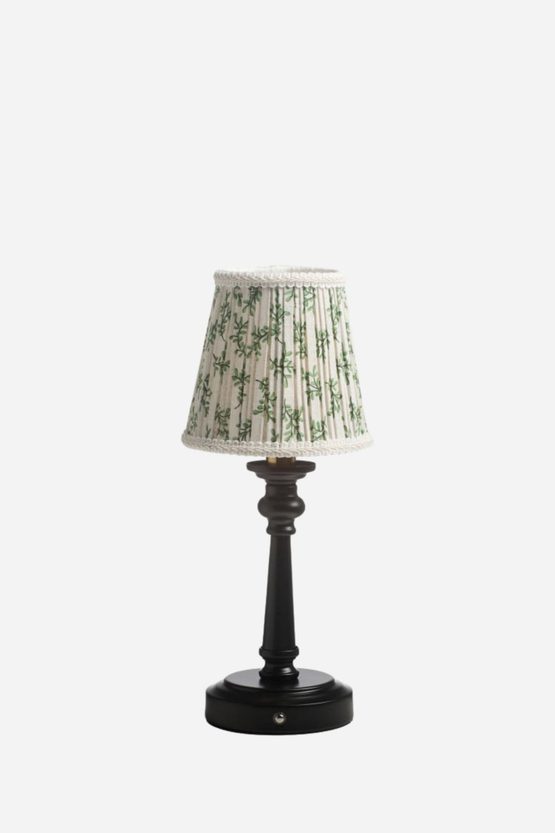 Small table lamp with a decorative lampshade on a white background