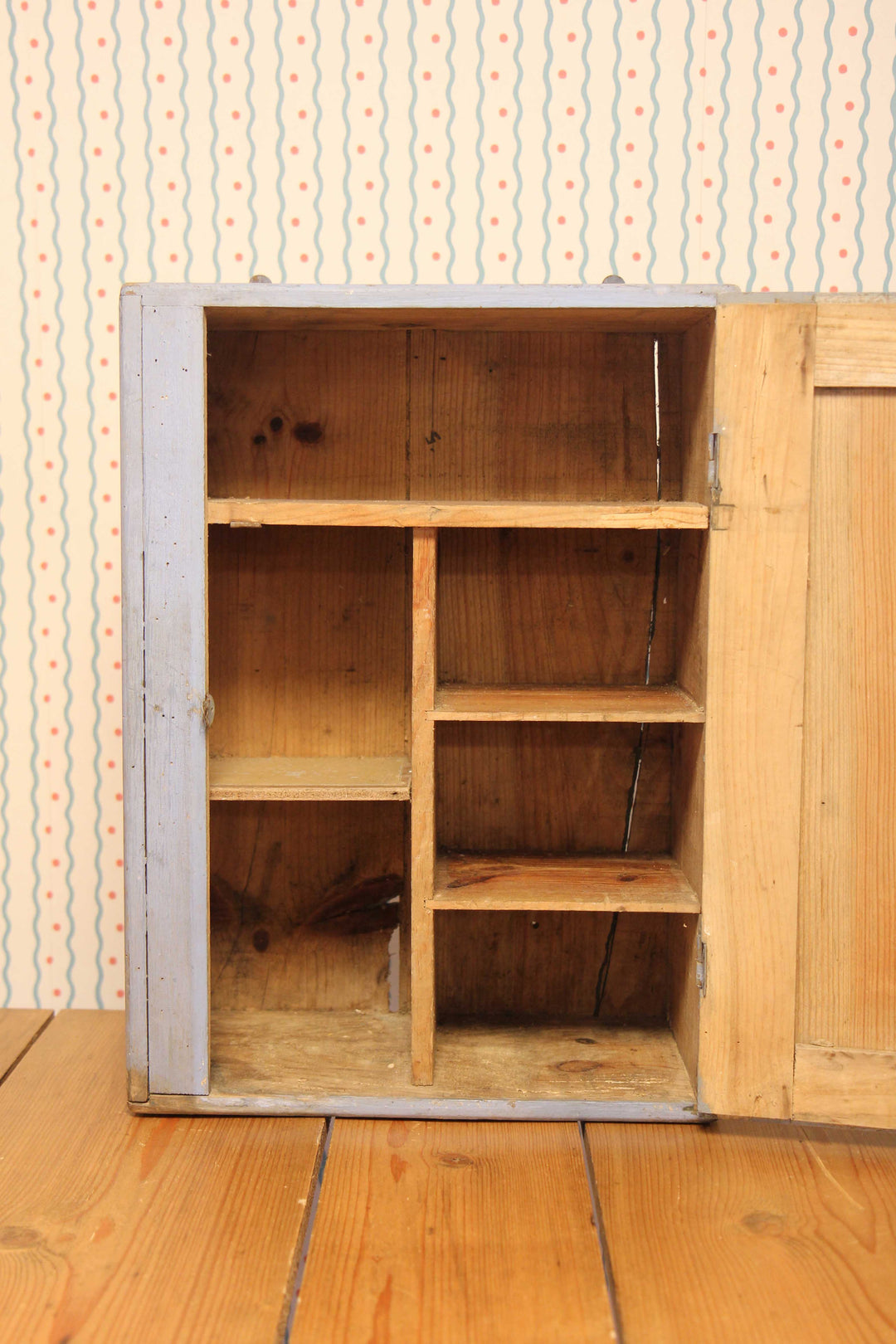 inside of blue painted small bathroom cabinet