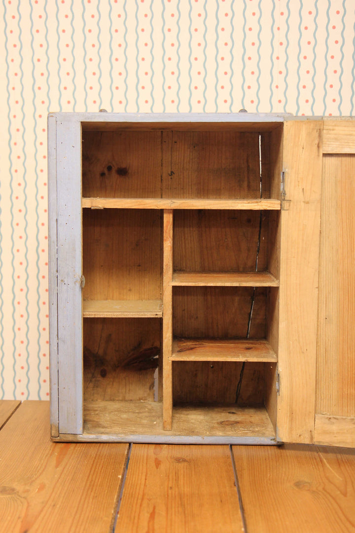 inside of blue painted small bathroom cabinet