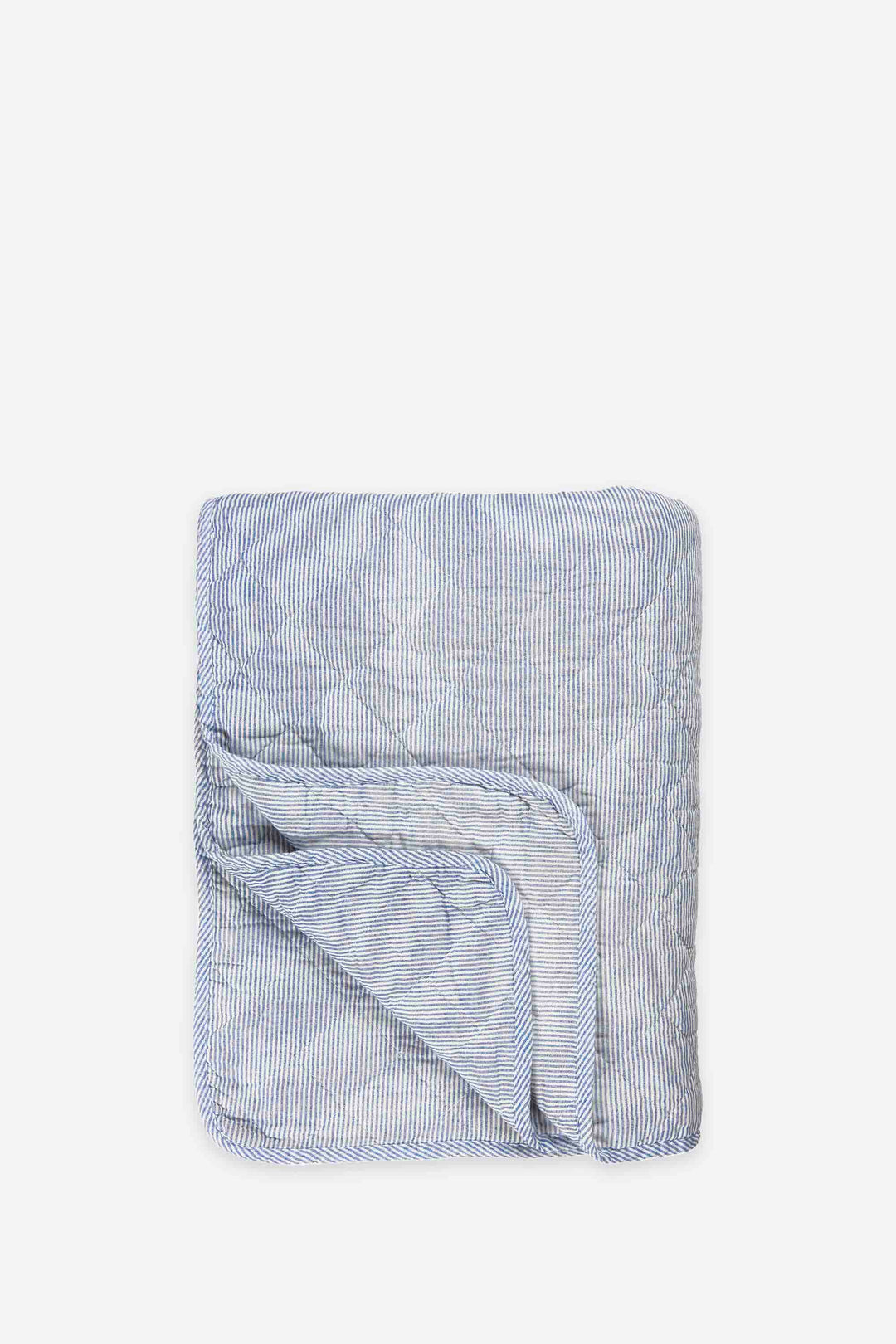 Folded blue and white striped towel on a white background