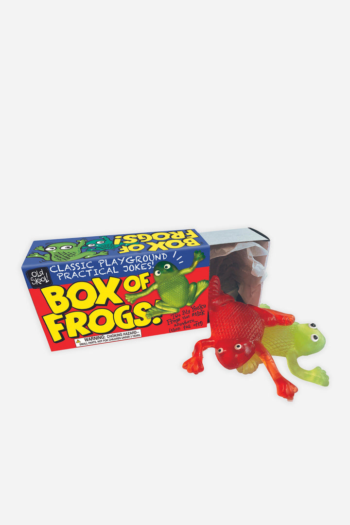 A box of 'Box of Frogs' toy, showing the product name and a few toy frogs outside the box.