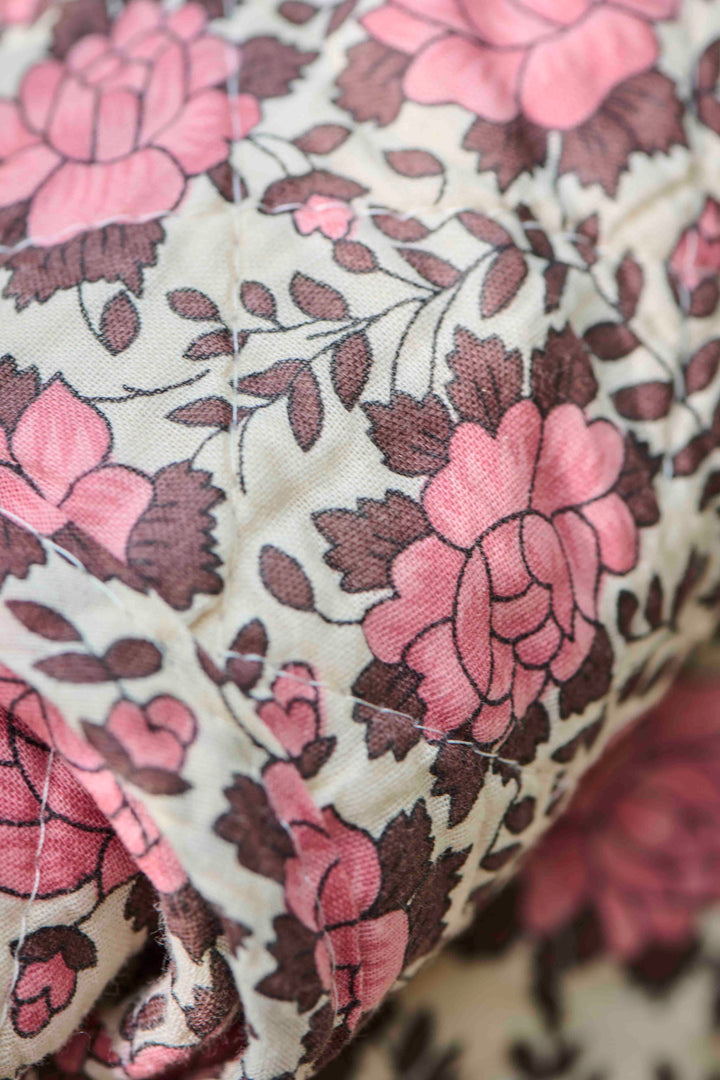close up detail of brown and pink floral quilt