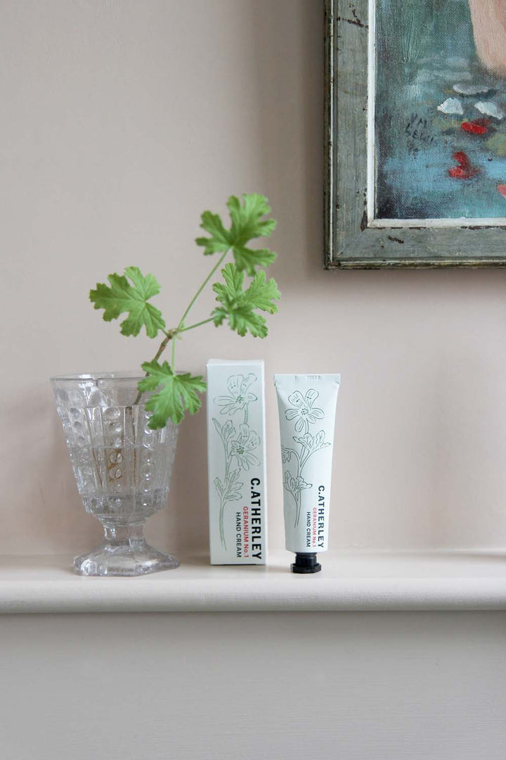 c.atherley geranium hand cream 30ml in pink bathroom with vintage vase full of geranium leaves