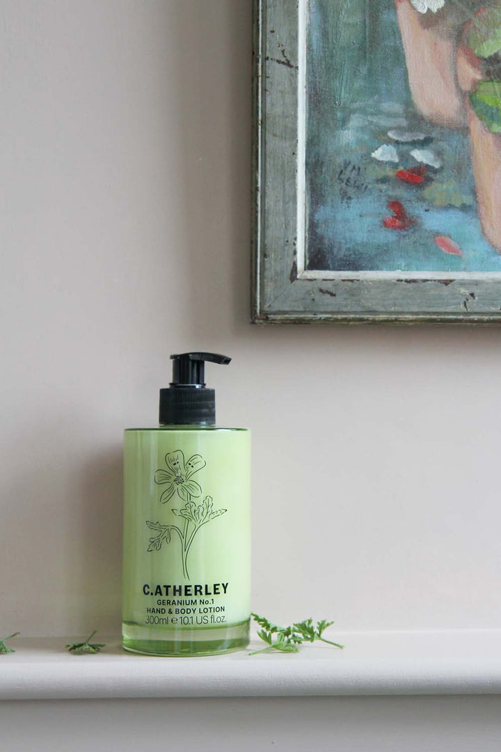 c.atherley geranium body lotion in green glass bottle in pink painted bathroom