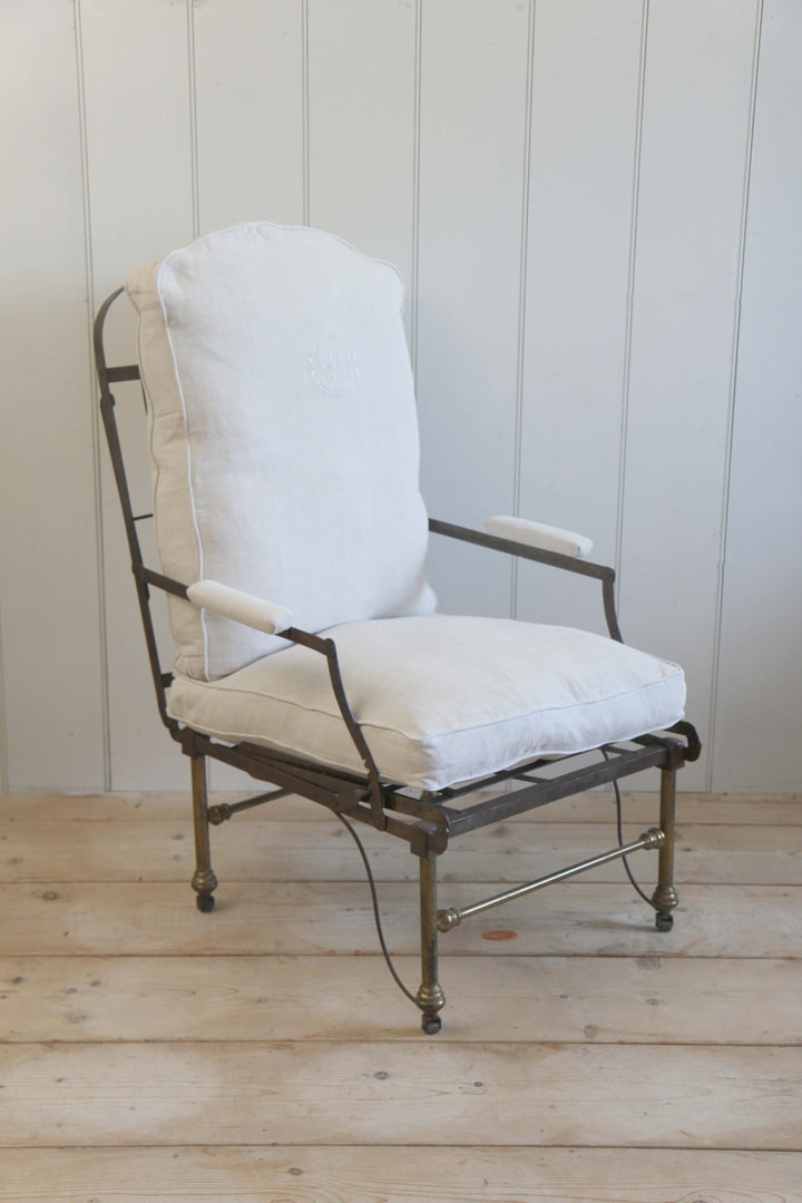 vintage campaign chair upholstered in cream canvas