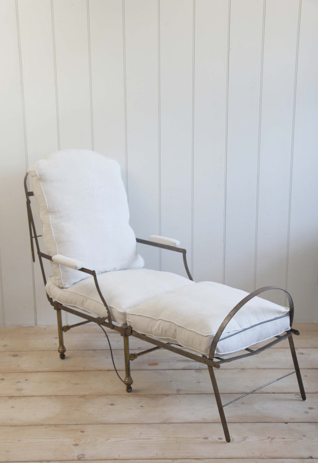 vintage campaign chair upholstered in cream canvas